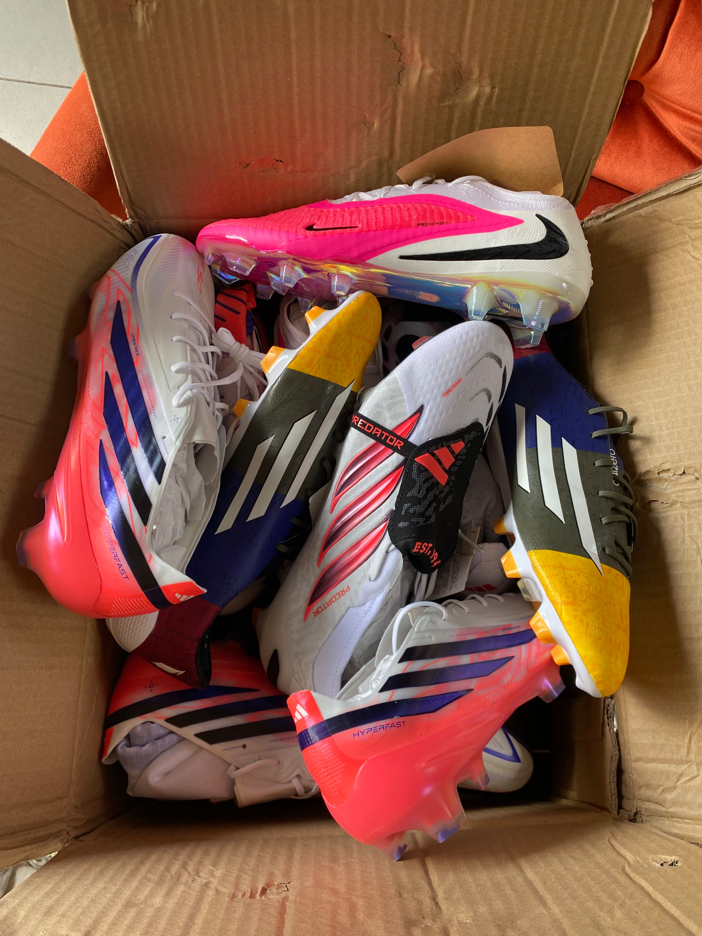 Box of Adidas and Nike football boots ready to ship